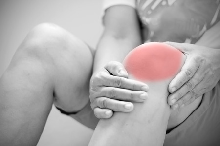 Old Asian women to knee injury on white backgroundの写真素材