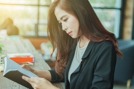 Asian woman reading a book for relaxationの写真素材