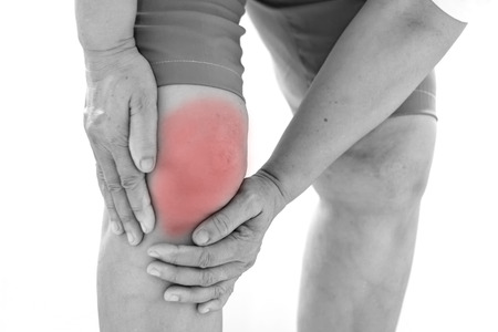 Old Asian women to knee injury on white backgroundの写真素材