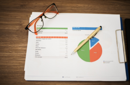 Blurry and soft focus of Business concept of office working and analysis graphics and clock on tableの写真素材