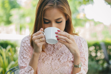 Asian business woman drinking coffee and business women smiling happy for workingの写真素材