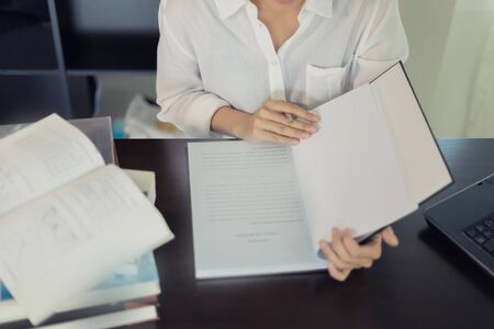 Asian women student reading a book for relaxation and final examの写真素材