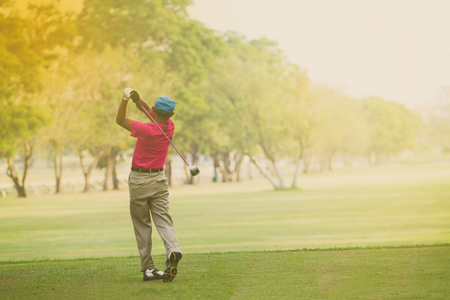 Asian golfers hit sweeping and keep golf course in the summer for relax time,soft focus and blurryの写真素材
