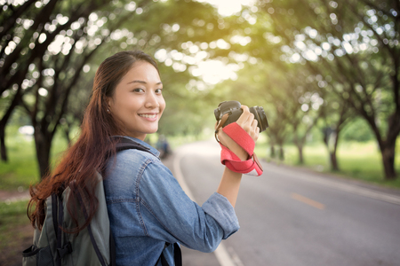 Women photographer holding a camera in the wild for take a photo of the tourist travelerの写真素材