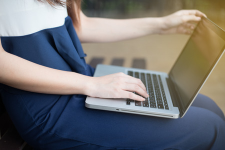 Asian business women using notebook for working at outdoorの写真素材