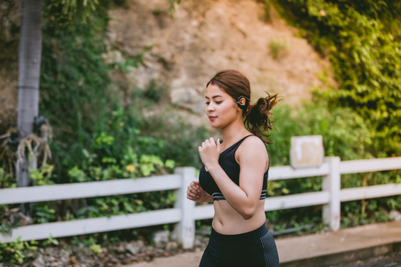 Asian women Running and jogging during outdoor on road in parkの写真素材