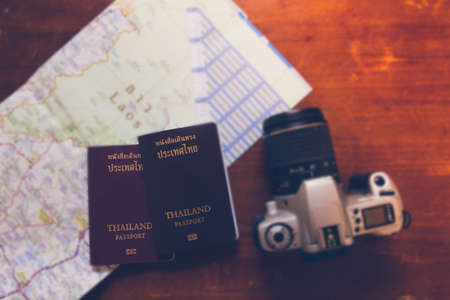 Thailand passport and camera on the map for World travel and travel asiaの写真素材