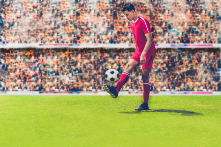 soccer or football player kicking ball on the field