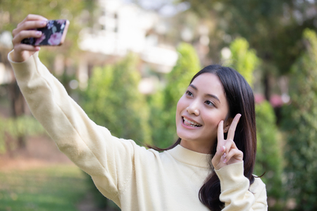 Asian Women smiling are taking photos and Selfieの写真素材