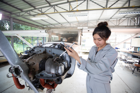 Asian men and women Engineers and technicians are repairing aircraft.のeditorial素材