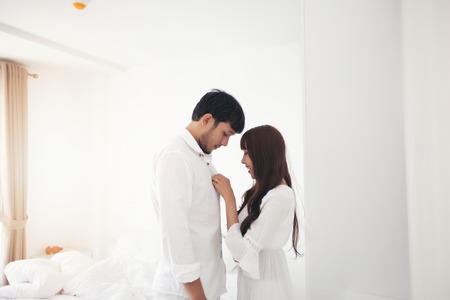 couples lover Laying On Bed Happiness Lifestyle and smiling girl relaxing in white bedの写真素材