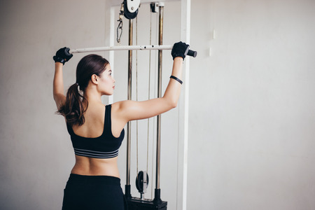 beautiful muscular fit woman exercising building muscles and fitness woman doing exercises in the...