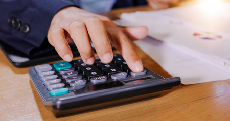 Businessmen are using calculators and analysis business data and and graph financial diagram working  at the meeting.の写真素材