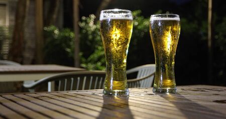 Asian group of friends having party with alcoholic beer drinks and Young people enjoying at a bar toasting cocktails and clinking glassesの写真素材