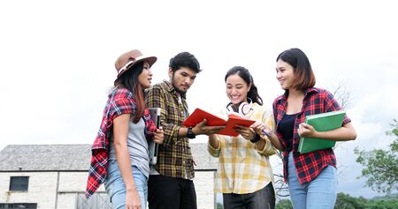 Group Students Smile and have fun It also helps to share ideas in the work and project. And also review the book before the exam outdoor in the garden.の写真素材