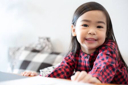 Asian Cute little girl sitting smilingの写真素材