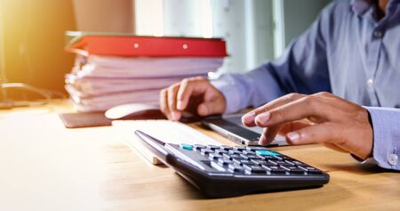 Businessmen are using calculators and analysis business data and and graph financial diagram working  at the meeting.の写真素材