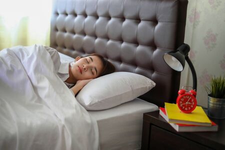 beautiful Asian woman sleeping in white bed.