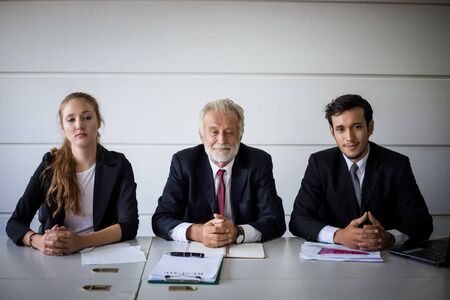Businessmen and Businesswomen discussing documents for job interview conceptの写真素材