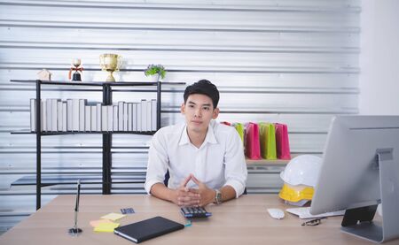 Asian man blogger broadcasting a video for selling product online such as Hats, shoes, headphones,...