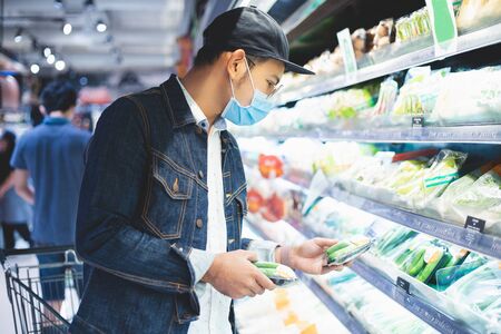 Asian men buy and shopping food  for hoarding in during the Covid outbreakの写真素材