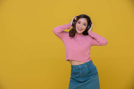 Smile happy Beautiful portrait young Asian woman stretching exercise workout on yellow background,...