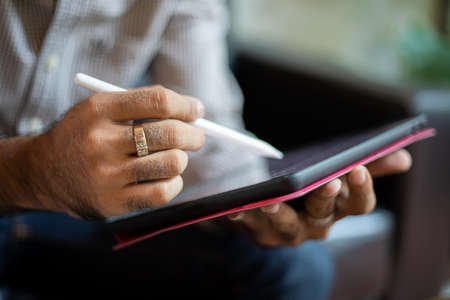Asian business men using a tablet for working at coffee shop