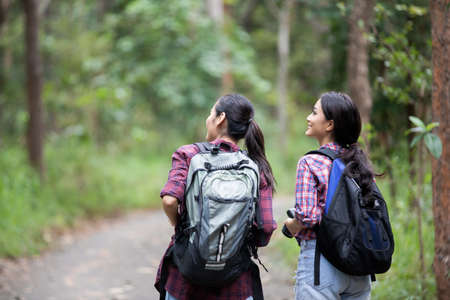 Asian Group of young people Hiking with friends backpacks walking together and looking map and...