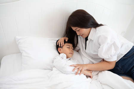 happy bedtime Child sleeping on bed with monの写真素材