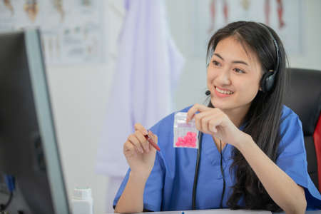 Asian women doctor talk by video chat consult patient online about symptoms and medications