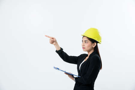 Asian women engineering inspecting and working and holding blueprints on white backgroundの写真素材