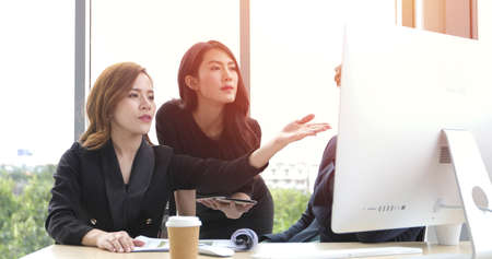 businessmen women  group using notebook for business partners discussing documents and ideas at meeting and business women smiling happy for workingの写真素材