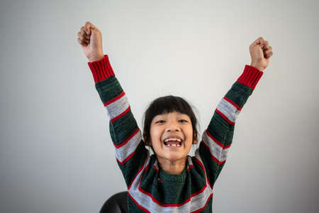 Asian girls enjoy and Raise your hand for happiness and successの写真素材