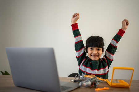 Asian girls enjoy learning online tutor training course at desk table enjoy making and fixing...