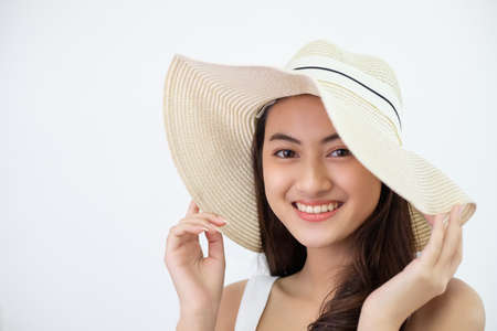 beauty portrait of young Asian woman wearing on a hat to travelの写真素材