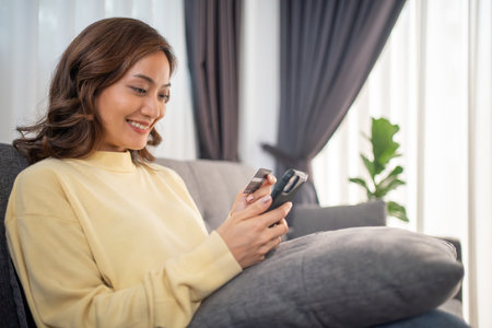 Women using Smart phone and Laptop for shopping online and payment with Credit card at homeの写真素材