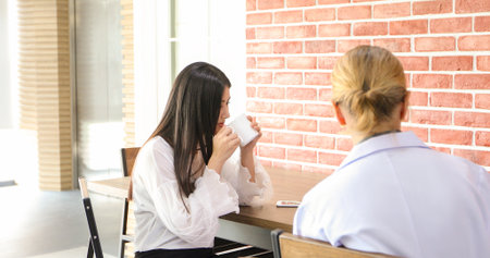 Researchers and scientists talking and drinking coffee at a cafe in their leisure time.