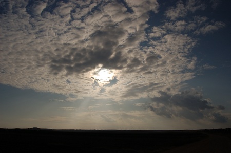 Sun peeking through cloudsの写真素材