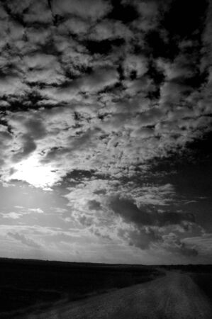 Country road under a cloudy skyの写真素材