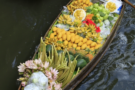 long-tail boat with fruits on the floating market の写真素材