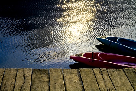 beautiful scenery ,wooden floor with some boats in lake,thailandの写真素材