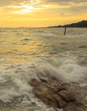 beautiful sunset and Ocean waves in the tropical sea の写真素材