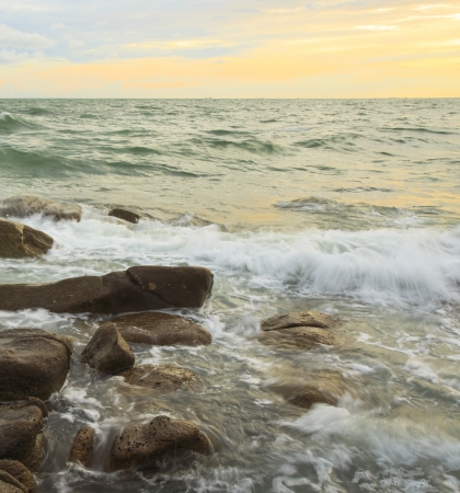 beautiful sunset and Ocean waves in the tropical sea の写真素材