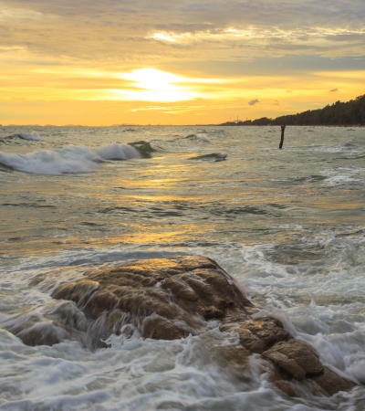 beautiful sunset and Ocean waves in the tropical sea の写真素材