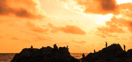 silhouette image of traveler at the sea and beautiful sunsetの写真素材