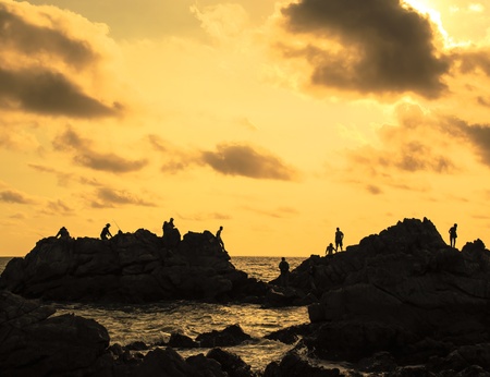 silhouette image of traveler at the sea and beautiful sunsetの写真素材