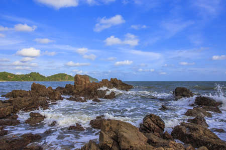 ocean waves crashing onto the rocky shore with beautiful sky , Thailand の写真素材