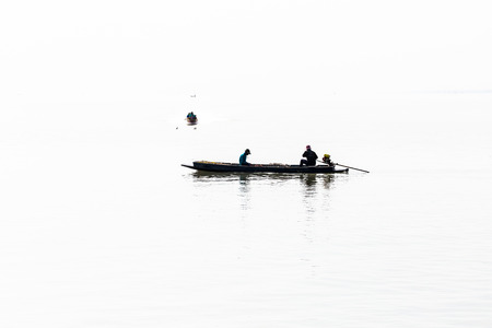 Fishermen collecting shellfish at cockle farming area in the seaの写真素材