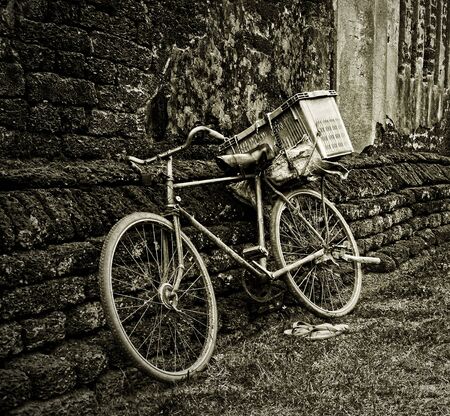 Old bicycle and brick wallの写真素材