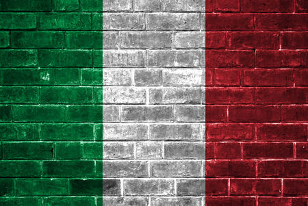 Italy flag on a brick wallの写真素材